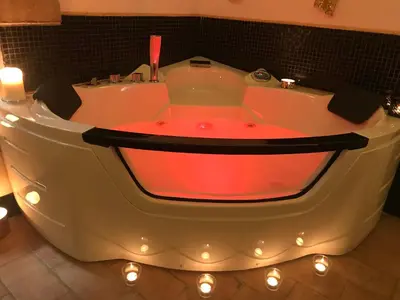 a bath tub with a red light in a bathroom at CasAphrodite in Rome