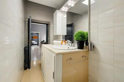 a bathroom with a sink and a mirror at TRIDENTE Apartment in Rome