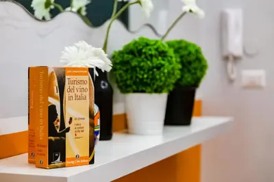 a shelf with a book and flowers and plants at TRIDENTE Apartment in Rome