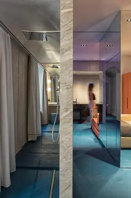 a room with a mirror and a person in a room at Etruscan Luxury Suites in Rome