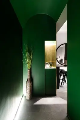 a green room with a vase with a plant in it at Etruscan Luxury Suites in Rome