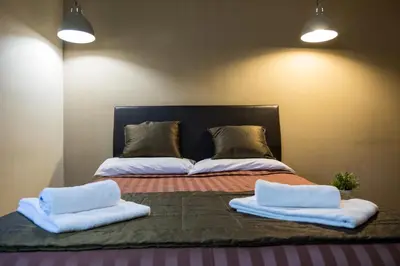 a bed with two white pillows on top of it at Aida Charming Rooms in Rome