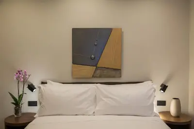 a bedroom with a bed with a painting on the wall at Clementi Portrait in Rome