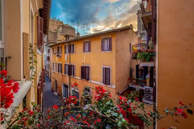 a view of an alley with buildings and flowers at Bollo Apartments in Rome