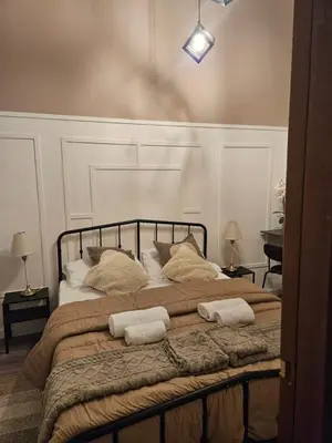 a bedroom with a large bed with two pillows on it at San Daniele Bundi House in Rome