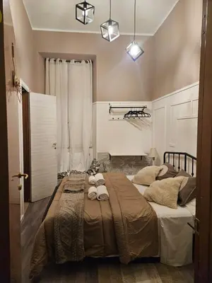a bedroom with a large bed with towels on it at San Daniele Bundi House in Rome