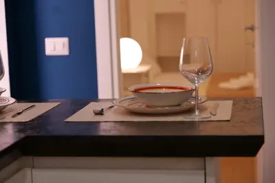 a bowl and a wine glass sitting on a counter at Deco's Place Roma Zoe in Rome