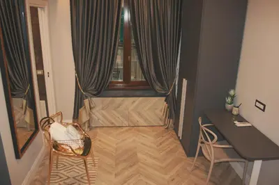 a room with a desk and a table and a window at Hotel Roma Vaticano in Rome