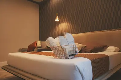 a hotel room with two beds and a basket of towels at Hotel Roma Vaticano in Rome