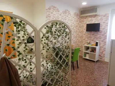 a room with a gate with a tv on a brick wall at Apartment Urbino 33 in Rome