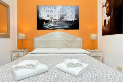 a bedroom with a bed with two towels on it at Restart Zingari Rome in Rome