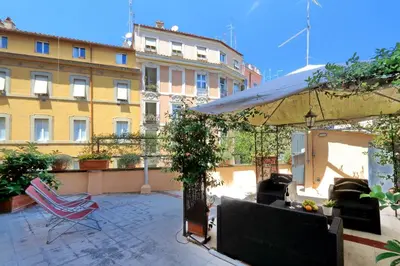 a patio with a tent and chairs and a building at Restart Zingari Rome in Rome