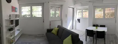 a living room with a couch and a table at OASI METROPOLITANA Apartment in Rome