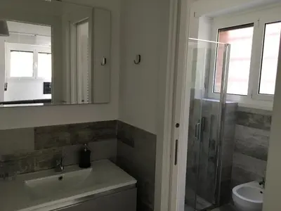 a bathroom with a sink and a toilet and a shower at OASI METROPOLITANA Apartment in Rome