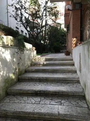 a set of stairs leading up to a building at OASI METROPOLITANA Apartment in Rome
