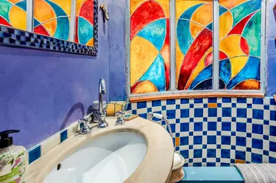 a bathroom with a sink and a stained glass window at Charming Bright Colosseum apartment in Rome
