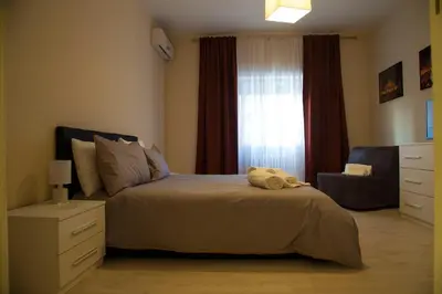 a bedroom with a bed with a dresser and a window at San Silverio Luxury House in Rome