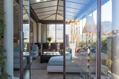 a living room with a couch and a table at Amazing Penthouse Piazza Venezia in Rome