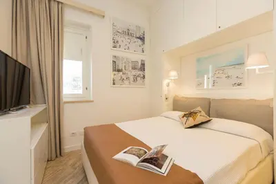 a hotel room with a bed with two books on it at Amazing Penthouse Piazza Venezia in Rome
