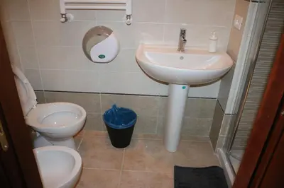 a bathroom with a sink and a toilet at R.T. HOUSE'S in Rome