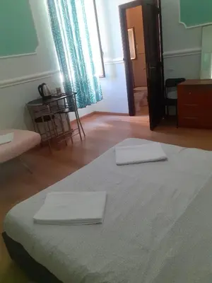 a bedroom with a bed with two white towels on it at R.T. HOUSE'S in Rome