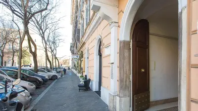 a street with cars parked on the side of a building at Rental in Rome Pompeo Magno in Rome