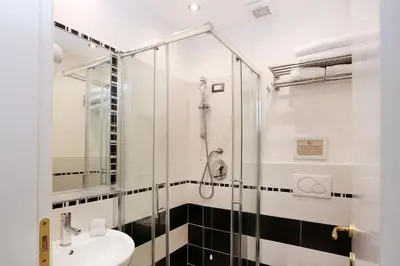 a bathroom with a shower and a sink at Daplace - HQH Colosseo in Rome