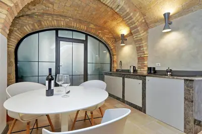 a kitchen with a white table and white chairs at Restart Accommodations Ada in Rome