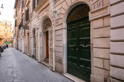 a green door on the side of a building at Maison Babuino in Rome