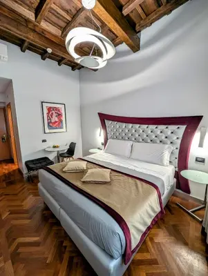 a bedroom with a large bed in a room at Relais Forus Inn in Rome