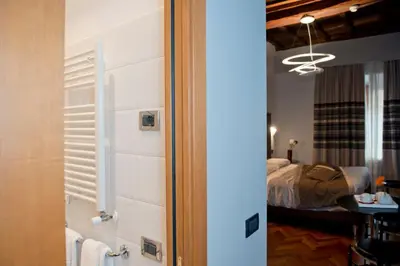 a room with a bedroom with a bed and a mirror at Relais Forus Inn in Rome