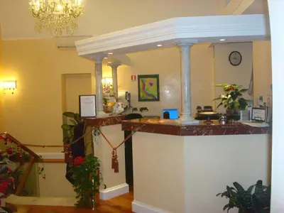 a lobby with a counter in the middle of a room at Hotel Demetra Capitolina in Rome