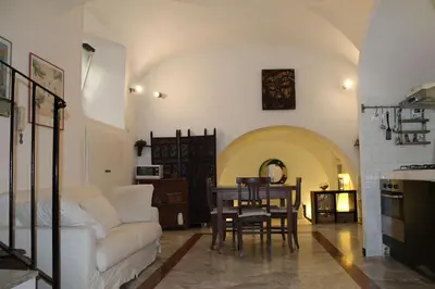a living room with a white couch and a table at Elly's Loft in Rome