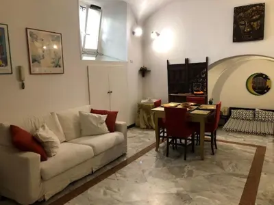 a living room with a couch and a table at Elly's Loft in Rome