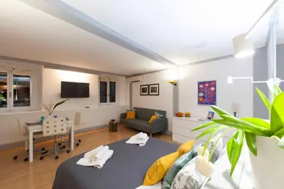 a living room with a bed and a couch at Casa Paola Guesthouse in Rome
