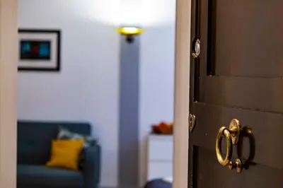 a door leading to a living room with a blue couch at Casa Paola Guesthouse in Rome