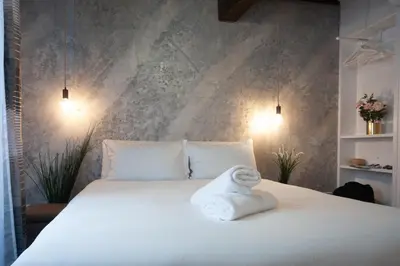 a white bed with a towel on top of it at Navona Jacuzzi Apartment in Rome