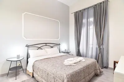 a bedroom with a bed with two towels on it at GuestHouse o Affittacamere Magenta Baylon Suite B in Rome