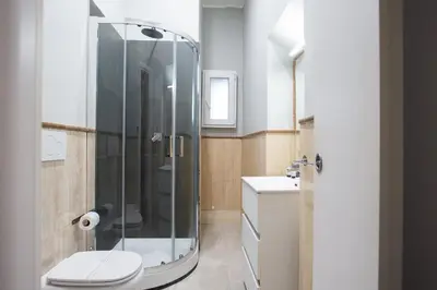 a bathroom with a shower with a toilet and a sink at GuestHouse o Affittacamere Magenta Baylon Suite B in Rome