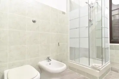 a bathroom with a toilet and a shower and a sink at GuestHouse o Affittacamere Magenta Baylon Suite B in Rome