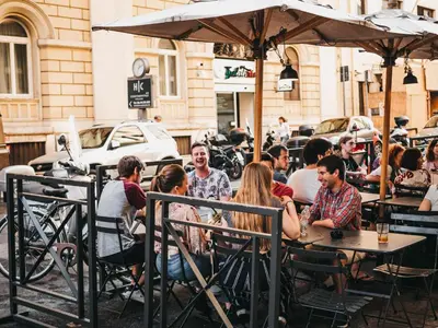 a group of people sitting at an outdoor restaurant at YellowSquare Rome in Rome