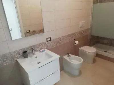 a bathroom with a sink and a toilet and a mirror at Rita a Trastevere in Rome