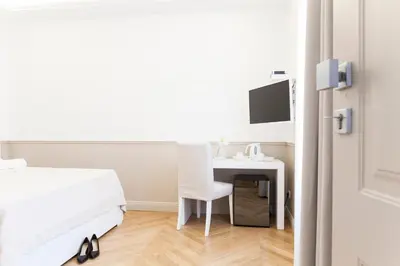 a bedroom with a bed and a desk with a computer at Vatican Suites - The Luxury Leading Accommodation in Rome in Rome