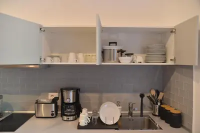 a kitchen counter with a sink and a coffee maker at All You Need is Rome Guesthouse in Rome