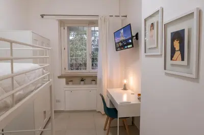 a bedroom with a desk and a bunk bed at La Casupola - Gemelli Garden in Rome