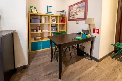 a room with a table and a book shelf at Difronte Ai Musei Vaticani in Rome