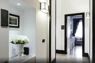 a hallway with a vase with white flowers in it at Residenza Scipioni Luxury B&B in Rome