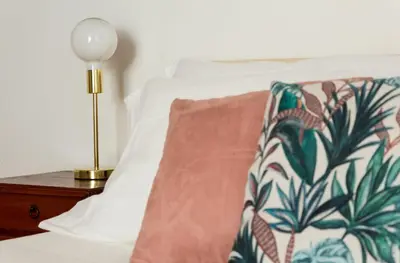 a bed with a pillow and a lamp on a night stand at Torripa Group - Trastevere in Rome