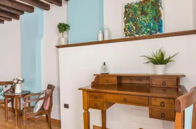 a wooden desk in a room with a table and chairs at Torripa Group - Trastevere in Rome