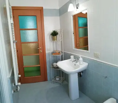 a bathroom with a sink and a mirror at Casa SereTina in Rome